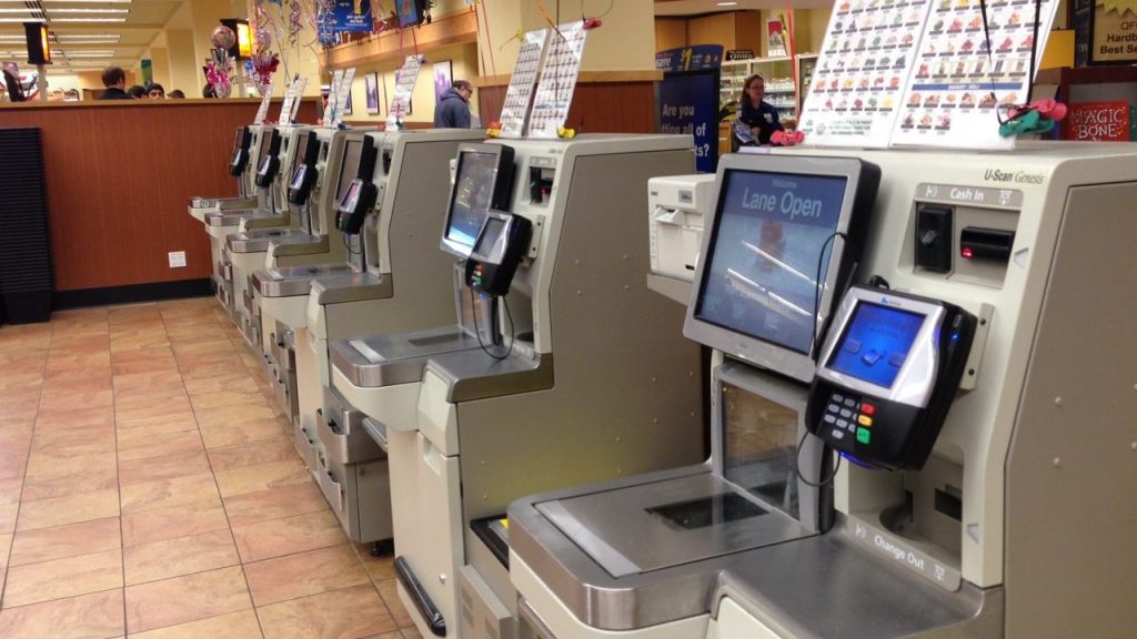 A row of self-checkout machines at a typical store.
